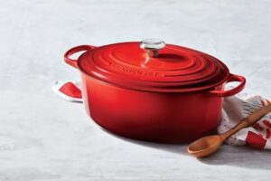 Le Creuset Enameled Cast Iron Signature Oval Dutch Oven, 9.5 qt., Cerise – Durable enameled cast iron cookware for superior heat retention and even cooking  
