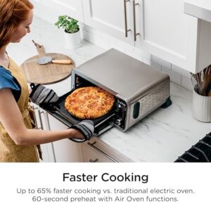Ninja SP300C Foodi 10-in-1 Dual Heat Air Fry Oven on countertop with cooking food